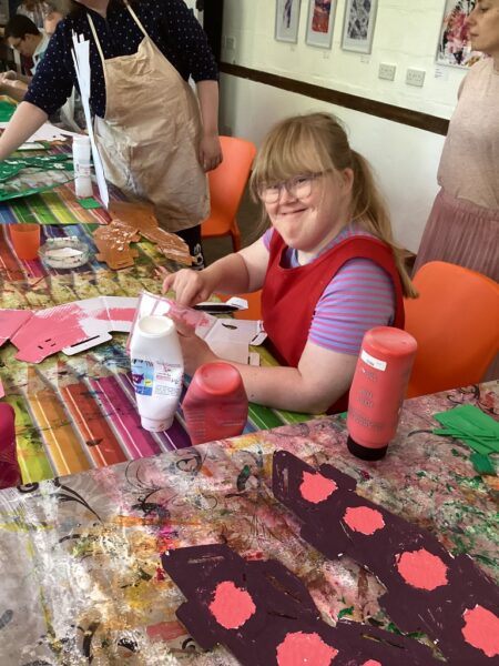 Participant painting cardboard pink