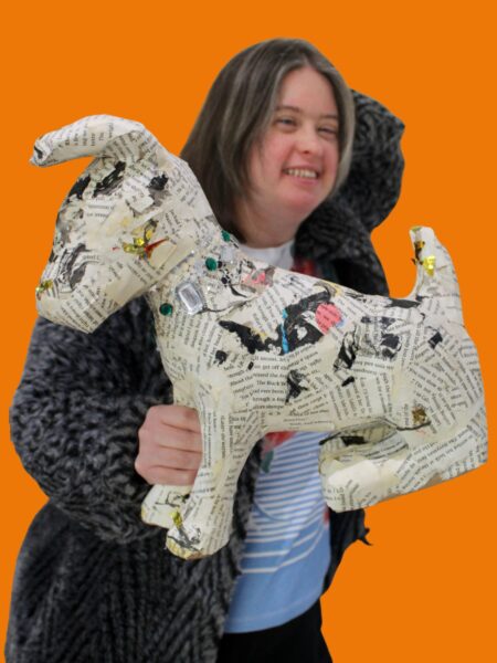 Participant with paper mache dog she made.