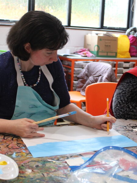 Participant painting a blue sky.