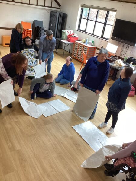 Theatre group people talking together and planning what they want to do on flip chart paper